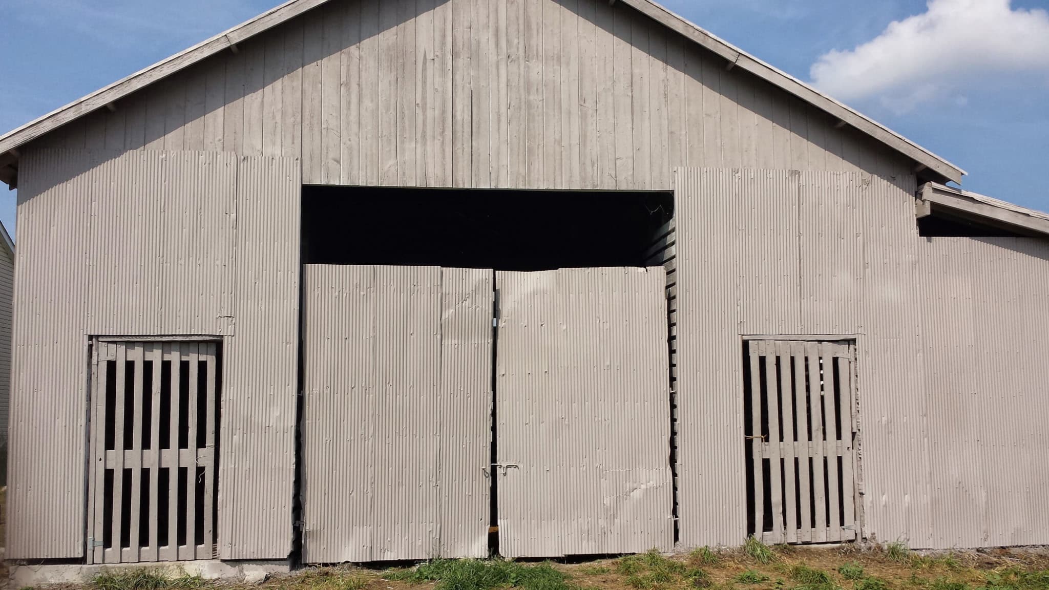 Repaired and repainted barn with rebuilt sliding doors