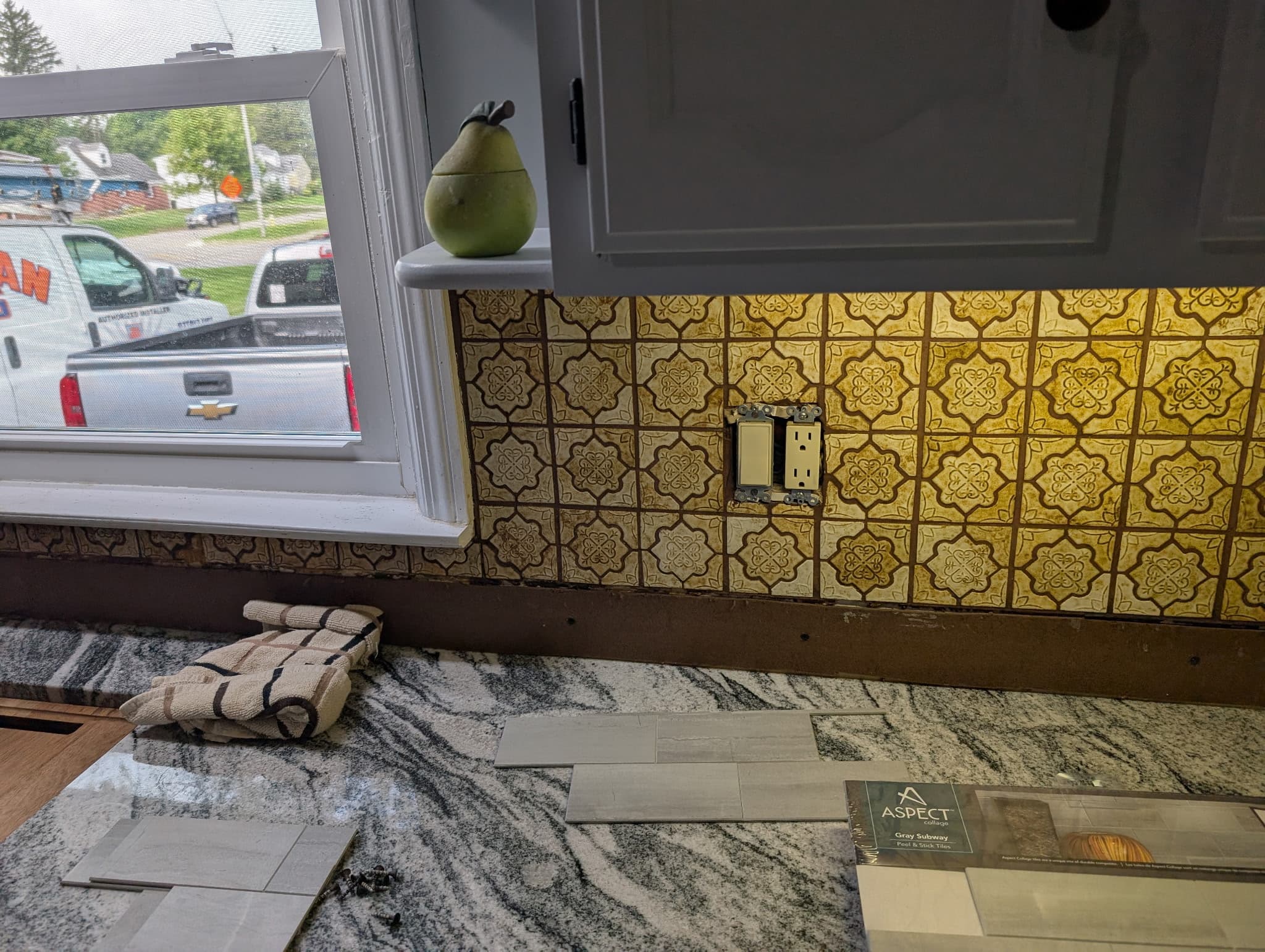 Patterned kitchen backsplash tile installed above granite counters